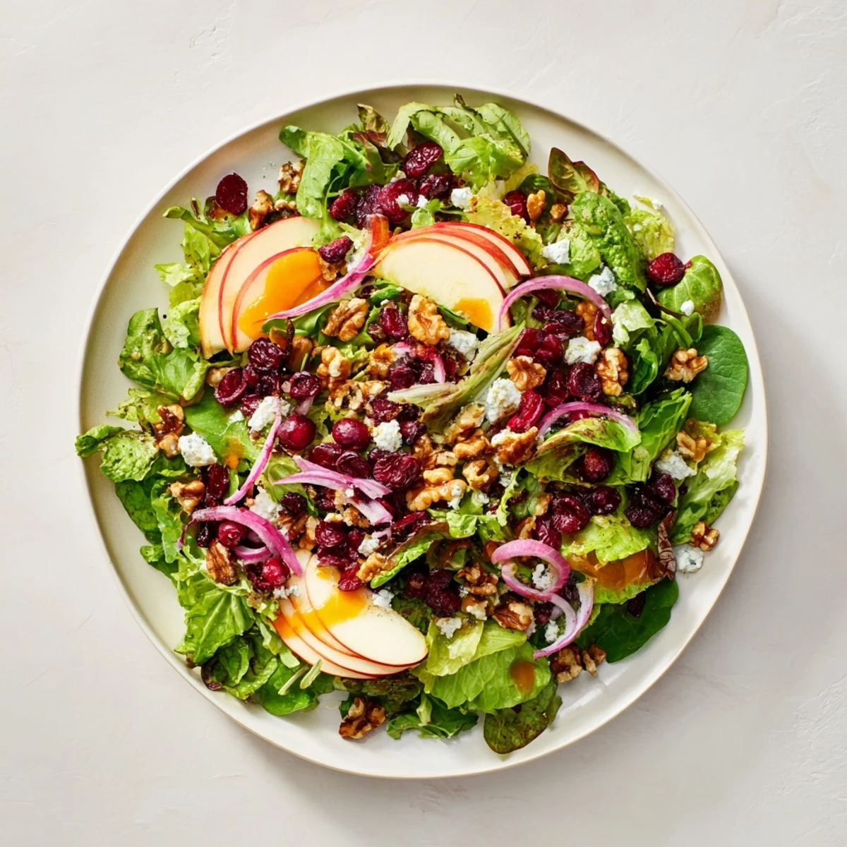 Bright, colorful Seasonal Cranberry and Walnut Celebration Salad with vibrant greens and zesty dressing.