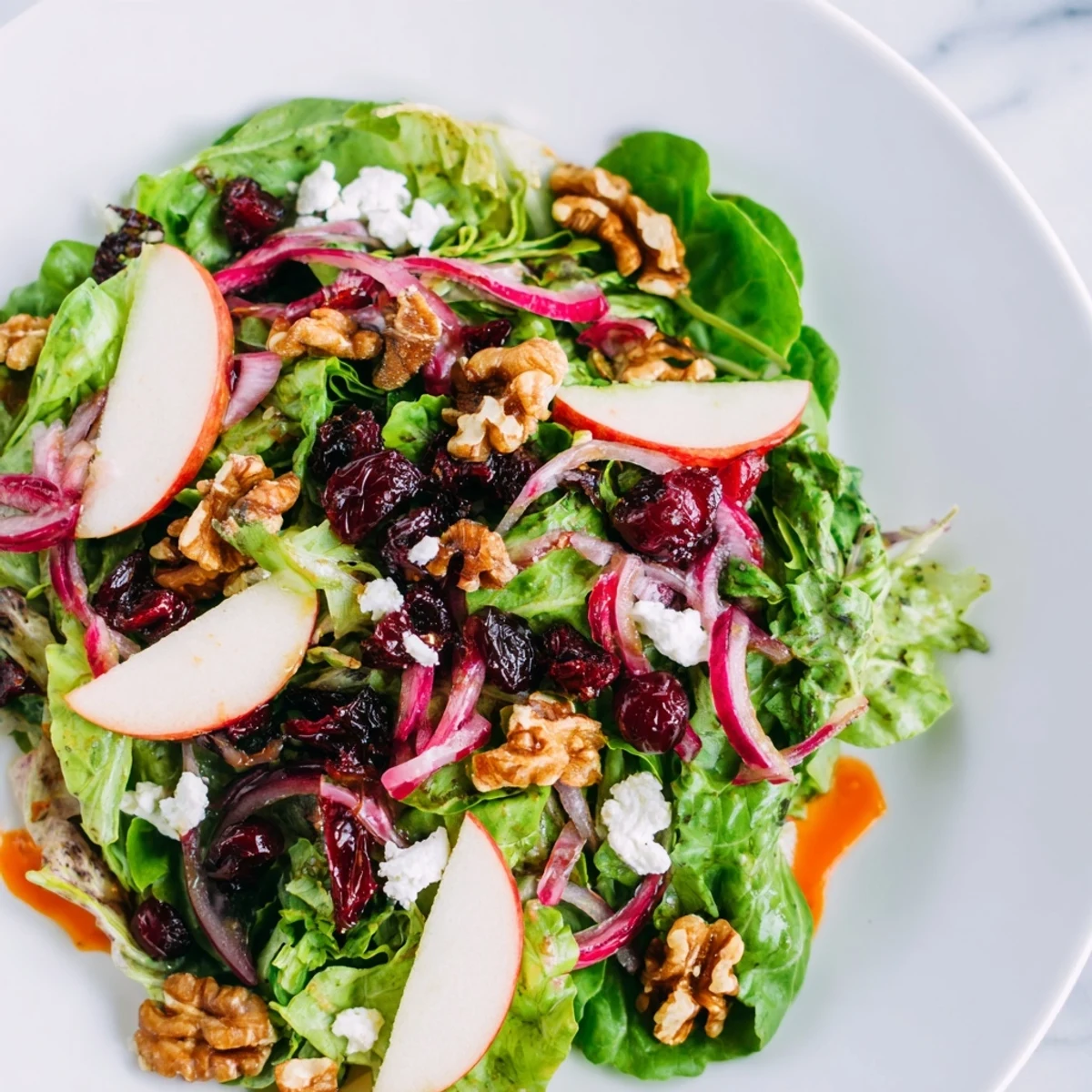 Fresh, crisp ingredients compose the flavorful Seasonal Cranberry and Walnut Celebration Salad, perfect for a gathering.