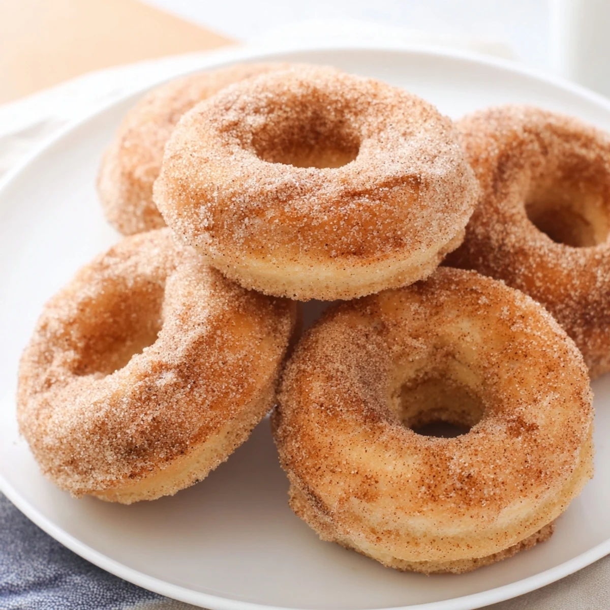 Warm, golden cinnamon-sugar baked donuts, perfect for breakfast or a sweet afternoon snack.