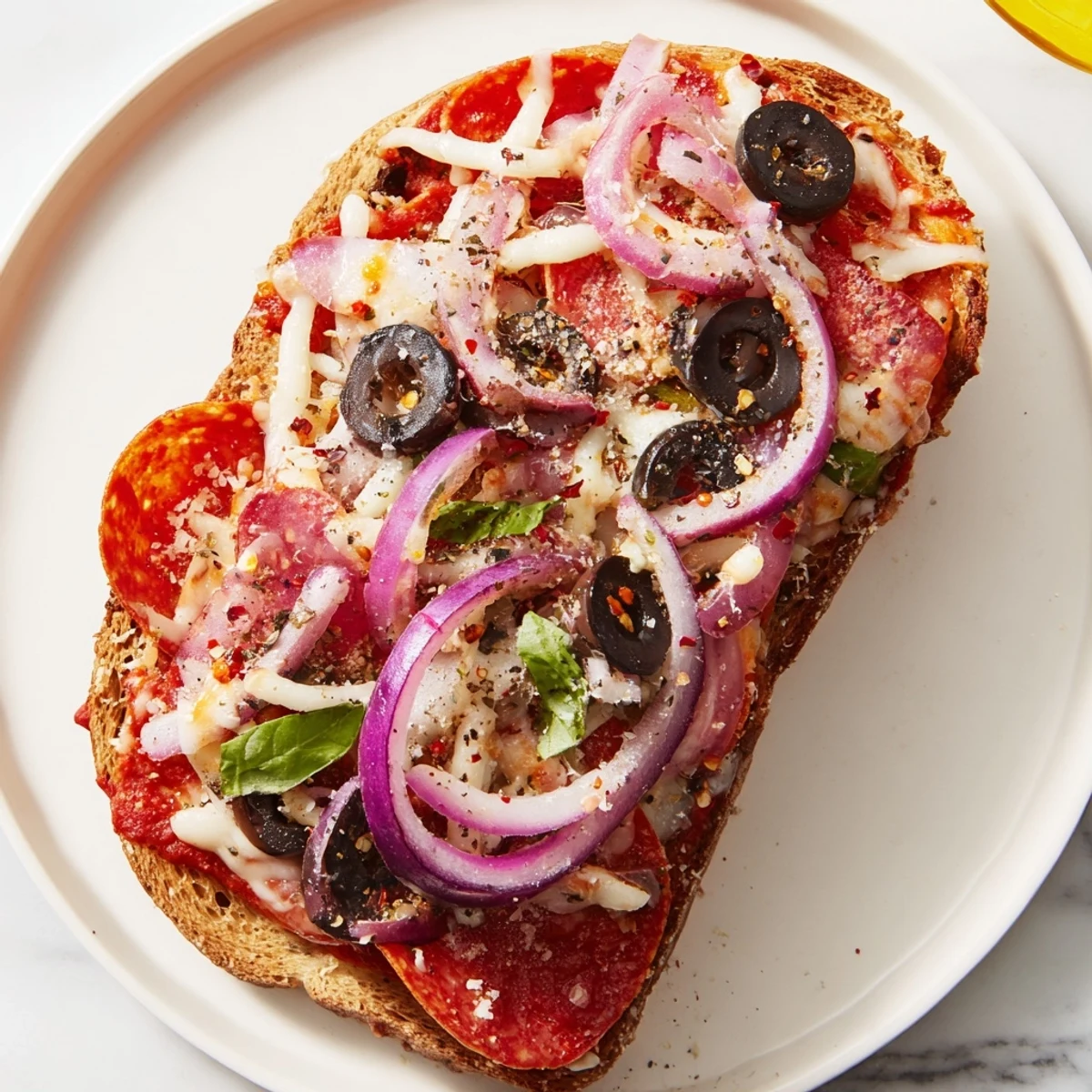 Pizza Toast 2.0 with bubbling cheese and crispy toppings, a perfect broiled snack.