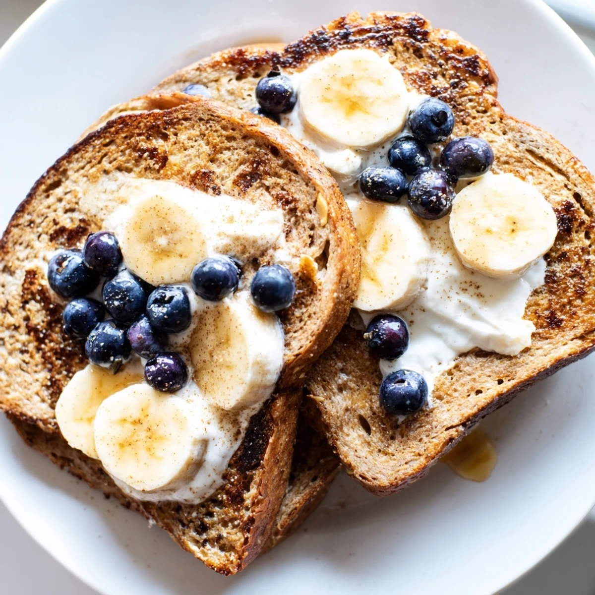 Golden, protein French toast, perfectly browned and topped with fresh berries, ready to eat.
