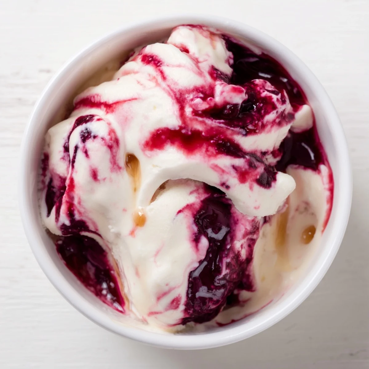 Scoops of rich, homemade cottage cheese ice cream, ready to serve in a bowl after chilling.