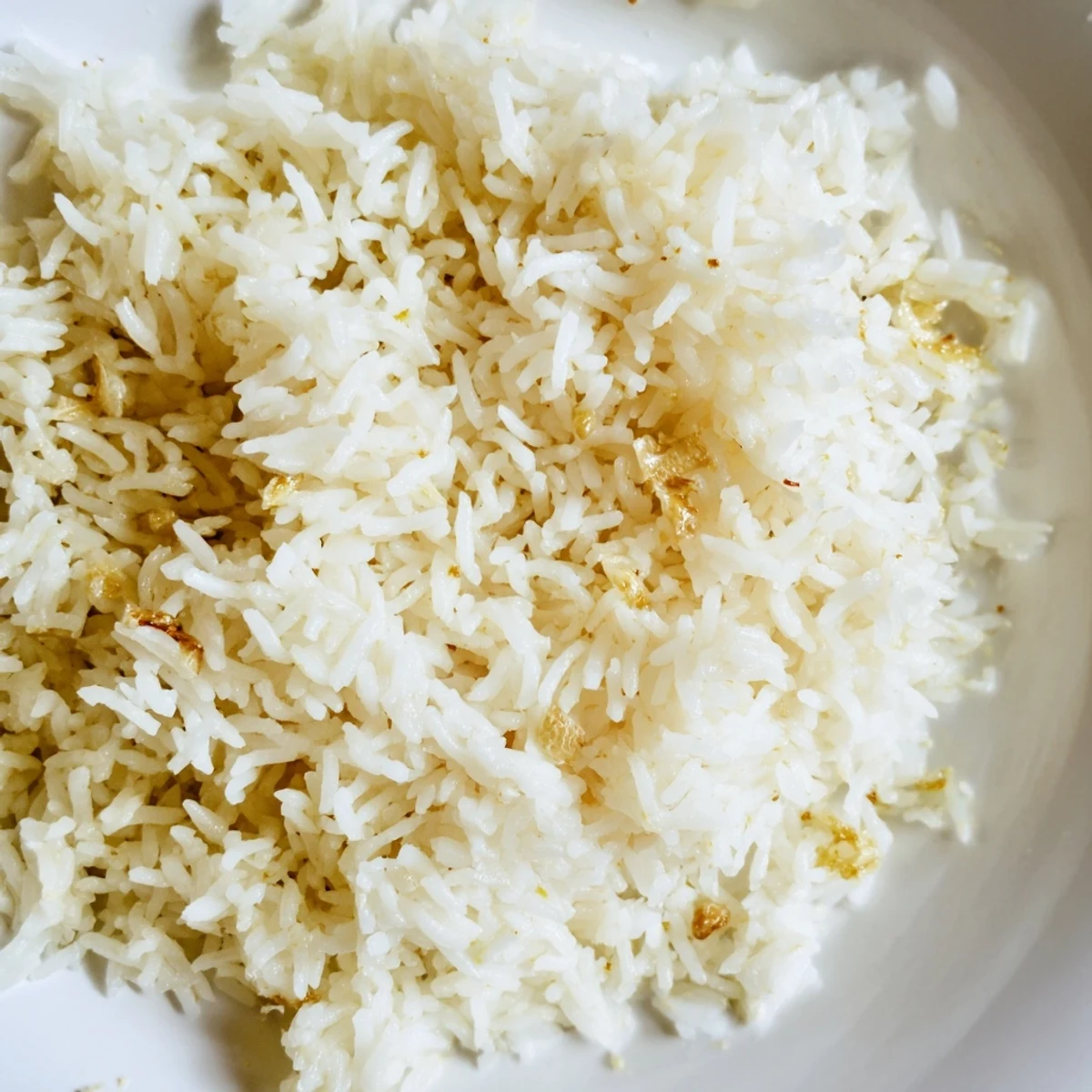 Savory garlic butter rice with grilled chicken breast, garnished with parsley and lemon wedges for a bright finish.