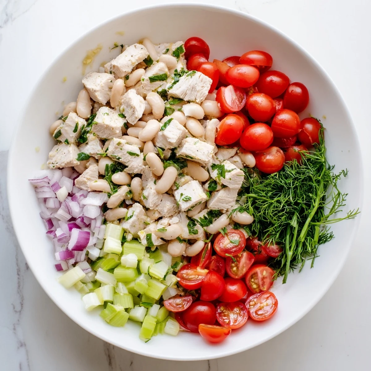 Bright, tangy Lemony White Bean Chicken Salad with shredded chicken, creamy white beans, crisp celery, and fresh herbs tossed in lemon vinaigrette.