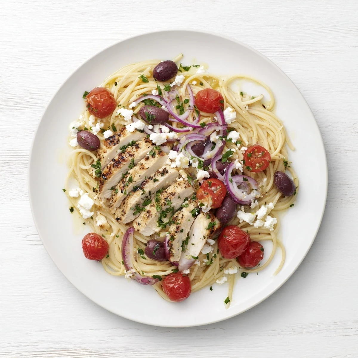 Grilled chicken, cherry tomatoes, and briny Kalamata olives tossed with spaghetti in a vibrant Greek Chicken Spaghetti.  