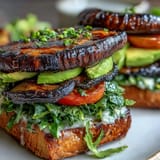 Hearty grilled portobello mushroom burgers, a satisfying vegetarian delight perfect for cookouts.