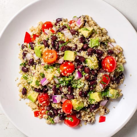 A colorful bowl displays the delicious ingredients in this healthy quinoa and black bean salad.