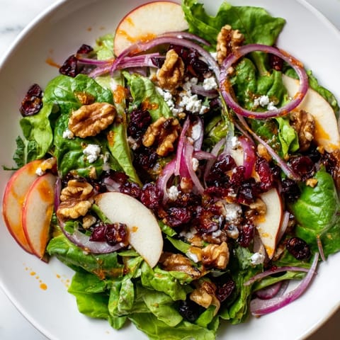 A close-up of a delightful Seasonal Cranberry and Walnut Celebration Salad, ready to be enjoyed with friends.