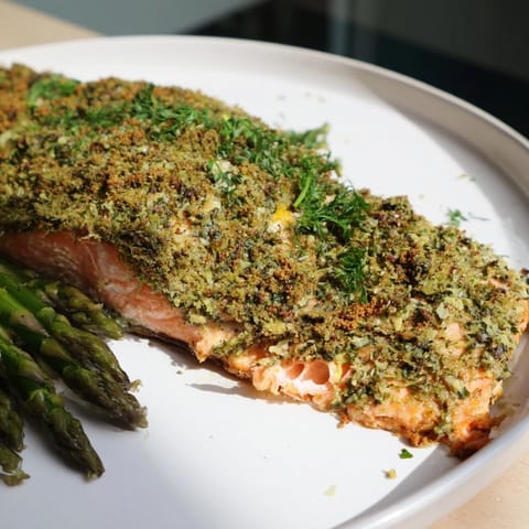 Easy Herb-Crusted Salmon with Asparagus, a flaky, oven-baked masterpiece, beside tender green asparagus.