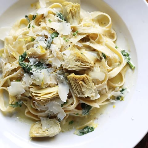A flavorful plate of creamy Lemon Artichoke Pasta, a vegetarian delight, ready for serving tonight.