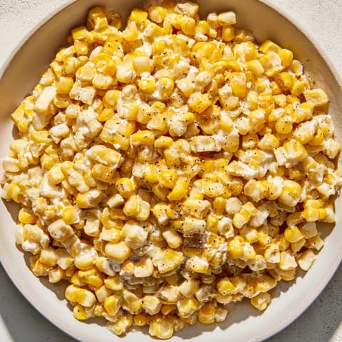 Warm honey butter skillet corn, glistening with melted butter, perfect for a family dinner.