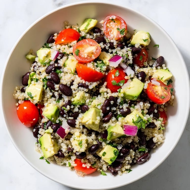 Bright, flavorful quinoa and black bean salad with creamy avocado, ready to be enjoyed.