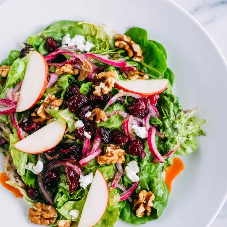 Fresh, crisp ingredients compose the flavorful Seasonal Cranberry and Walnut Celebration Salad, perfect for a gathering.