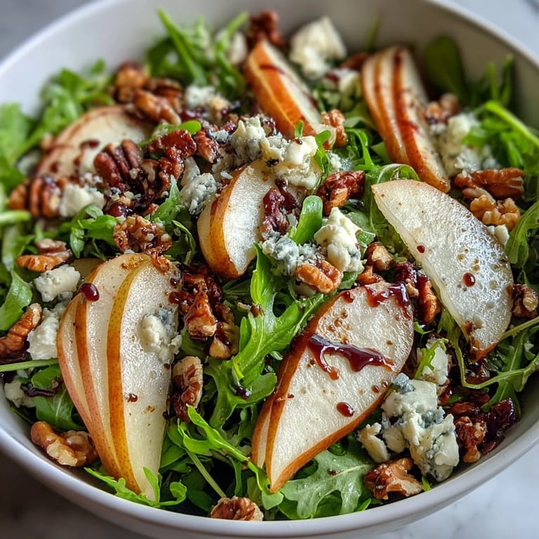 Arugula and Pear Bowl with balsamic drizzle and walnuts, served as a refreshing vegetarian main or starter.