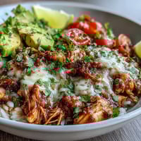 Colorful salsa chicken bowls with shredded chicken, rice, black beans, corn, and fresh toppings for a hearty meal.  